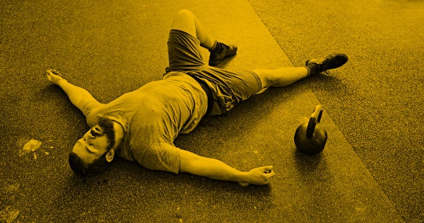man laying down post workout exhausted