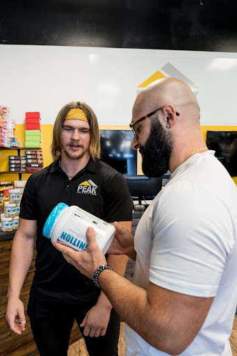 men looking at supplements in a nutrition store